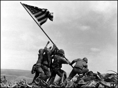 US Marines of the 28th Regiment of the 5th Division, raise the American flag atop Mt Suribachi,