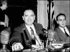 Senator Joe McCarthy in front of microphones