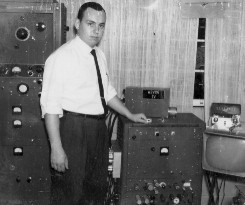 Behind me is a 1,000 watt transmitter I built from scratch.  My hand rests on the 100 watt TV transmitter, synchronizing circuits and TV camera... all of my own design.