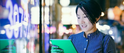 A person in blue shirt looking at a tablet