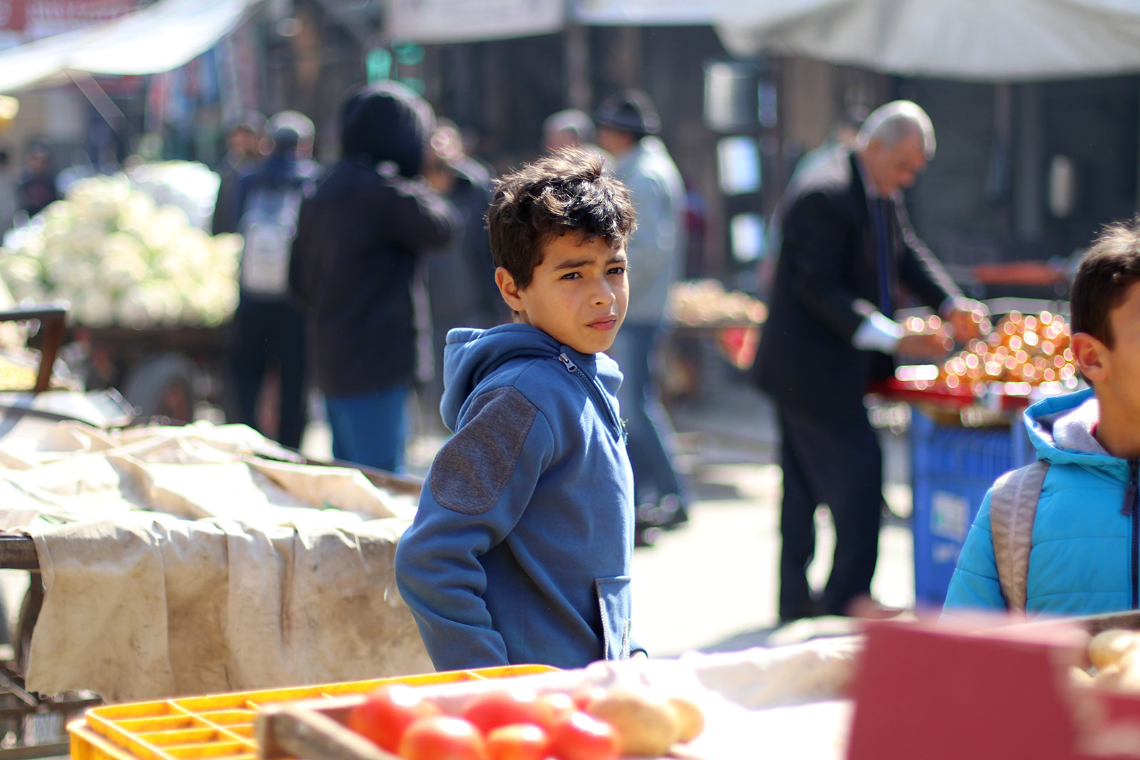Boy in front of a grocery stall
