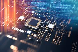 A blue circuit board with gold and white components, featuring a central dark microchip.