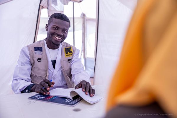 Male humanitarian aid worker at his desk in tent