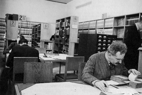 Photograph of Walter Benjanmin working in a library