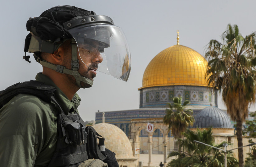 An Israeli security officer looks on at Dome of the Rock on Temple Mount in Jerusalem
