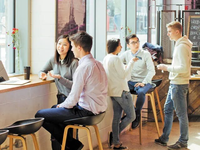 Article header image, students conversing in a cafe