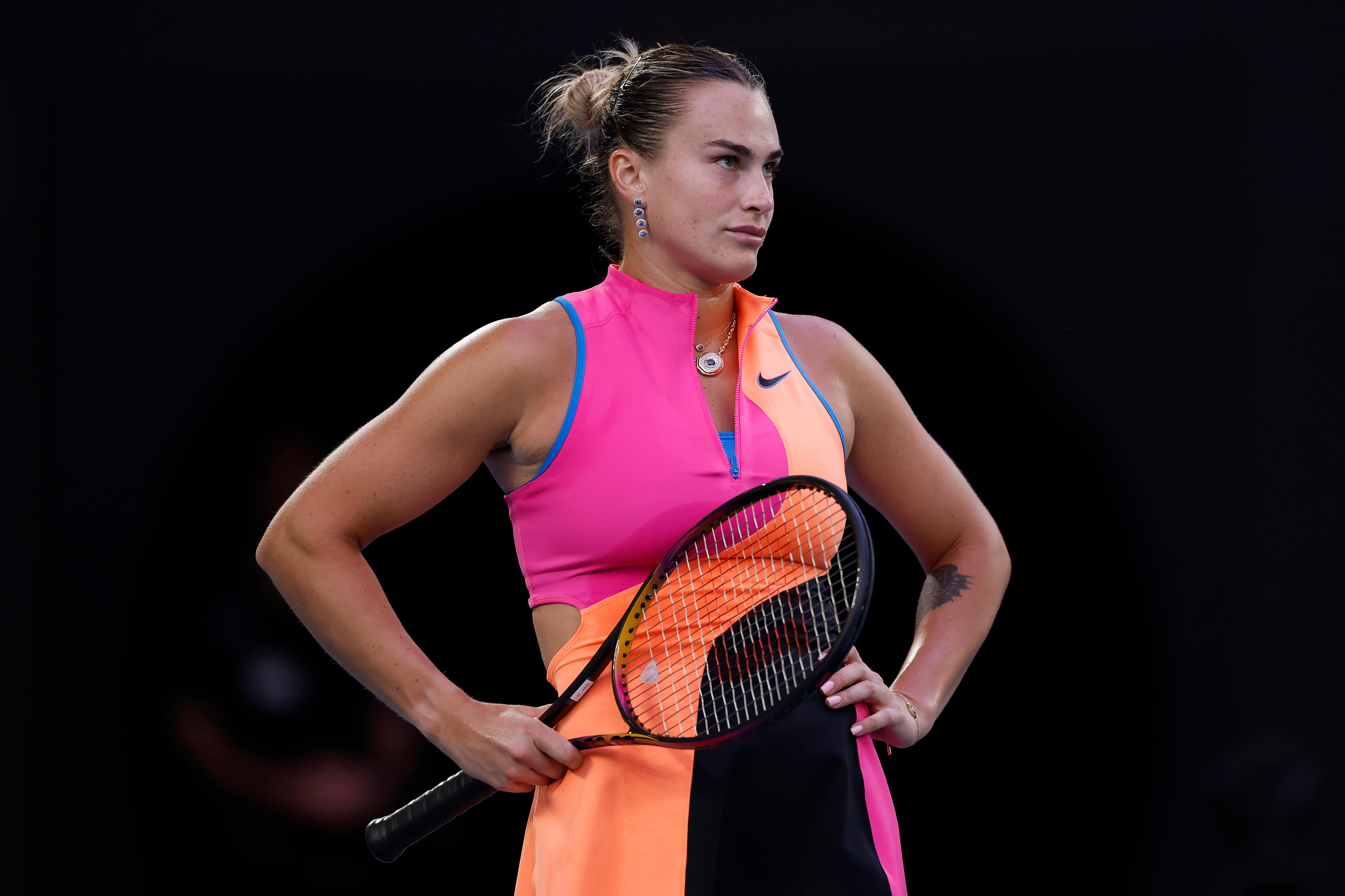 Aryna Sabalenka looks unhappy with her hands on her hips during an Australian Open match.