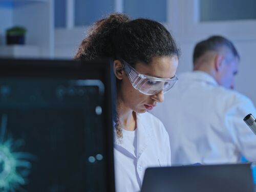 Medical scientists developing vaccine in modern laboratory, studying new viruses