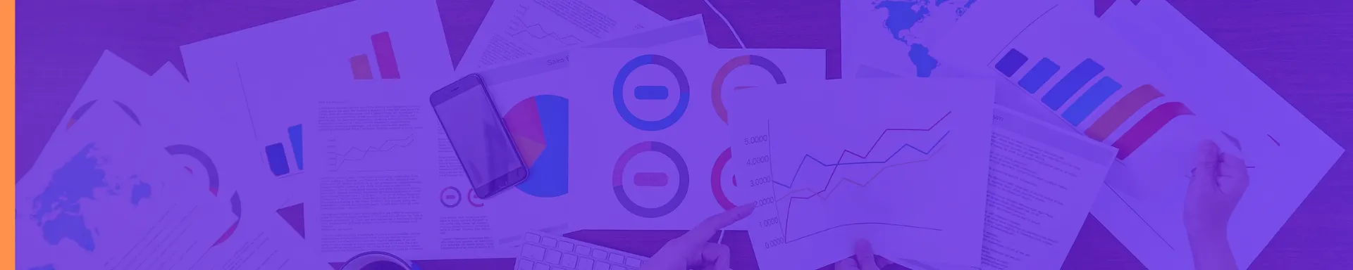 Multiple charts and graphs on A4 paper scattered on a table