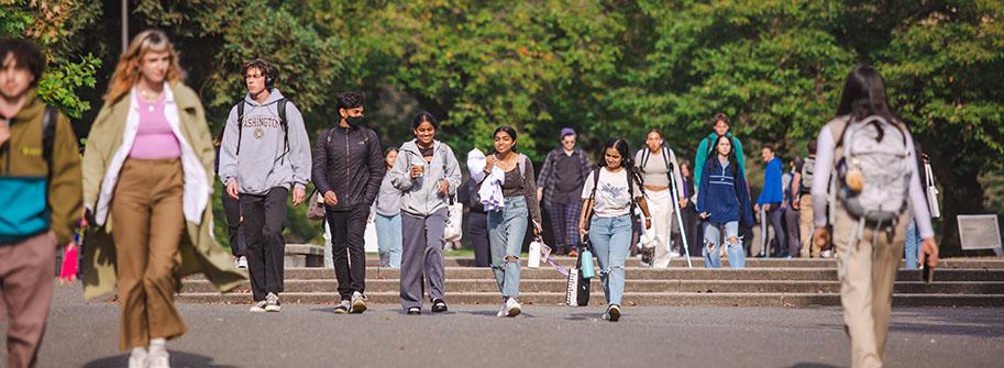 students walking, talking and smiling through the quad