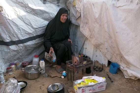 10. الصورة العاشرة: خولة مقداد نازحةٌ تحول زاوية خيمتها إلى غرفة غاز صغيرة بفعل حرق النفايات والبلاستيك السام. 22 أبريل 2026 – تصوير الجزيرة نت.