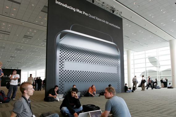 SAN FRANCISCO - AUGUST 07: Conference attendees at the 2006 Apple Worldwide Developer's Conference work on their laptops before a poster featuring the new Apple Mac Pro desktop at the August 7, 2006 in San Francisco. Apple CEO Steve Jobs kicked off the annual conference with announcements of a new Mac Pro desktop computer featuring Intel processors and Mac OSX Leopard operating system that is due to launch in the spring of 2007. (Photo by Justin Sullivan/Getty Images)