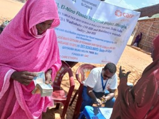 Batula receiving the cash assistance