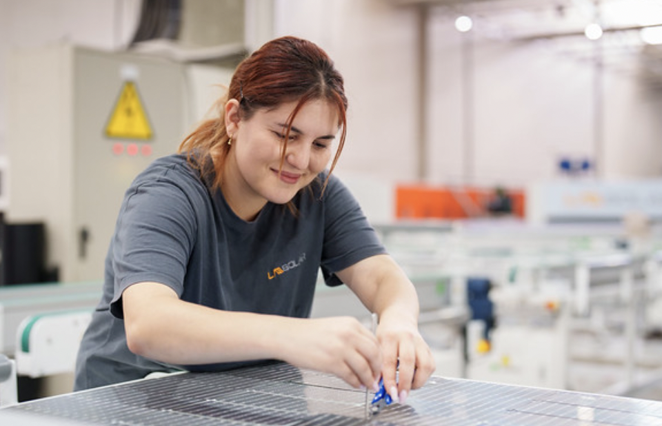 woman operating machinery in factory
