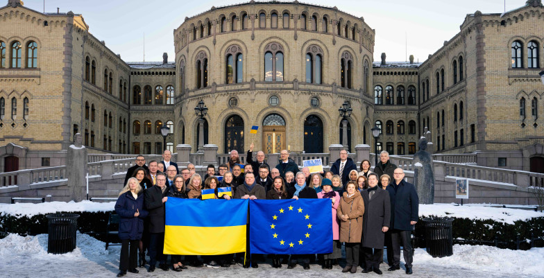 group photo holding Ukraine and EU flags