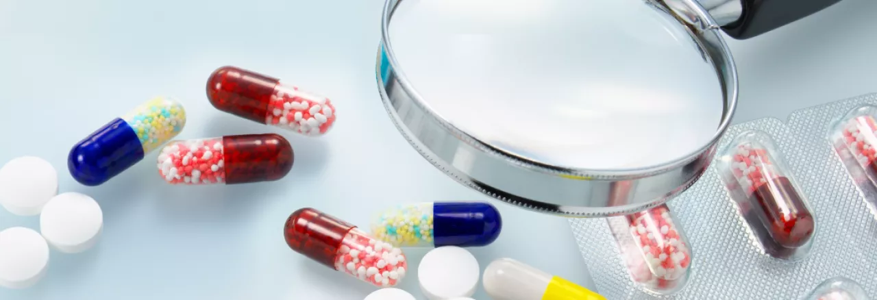 Image showing pills and a magnifying glass
