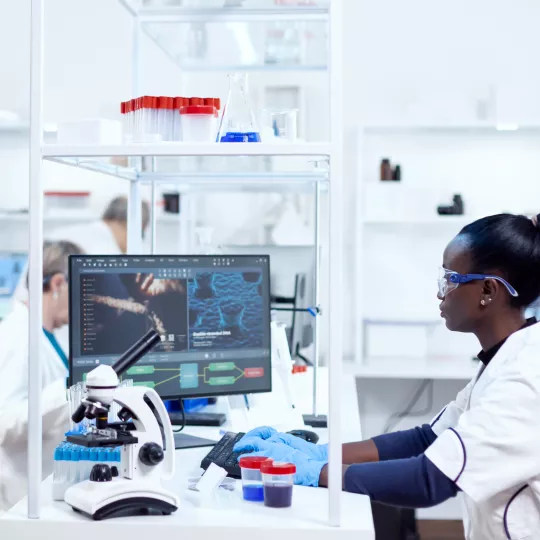 Scientist looking at computer screen in laboratory