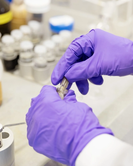 Scientist in the lab with globes on