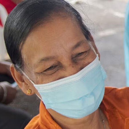 woman with face mask getting vaccinated against COVID-19