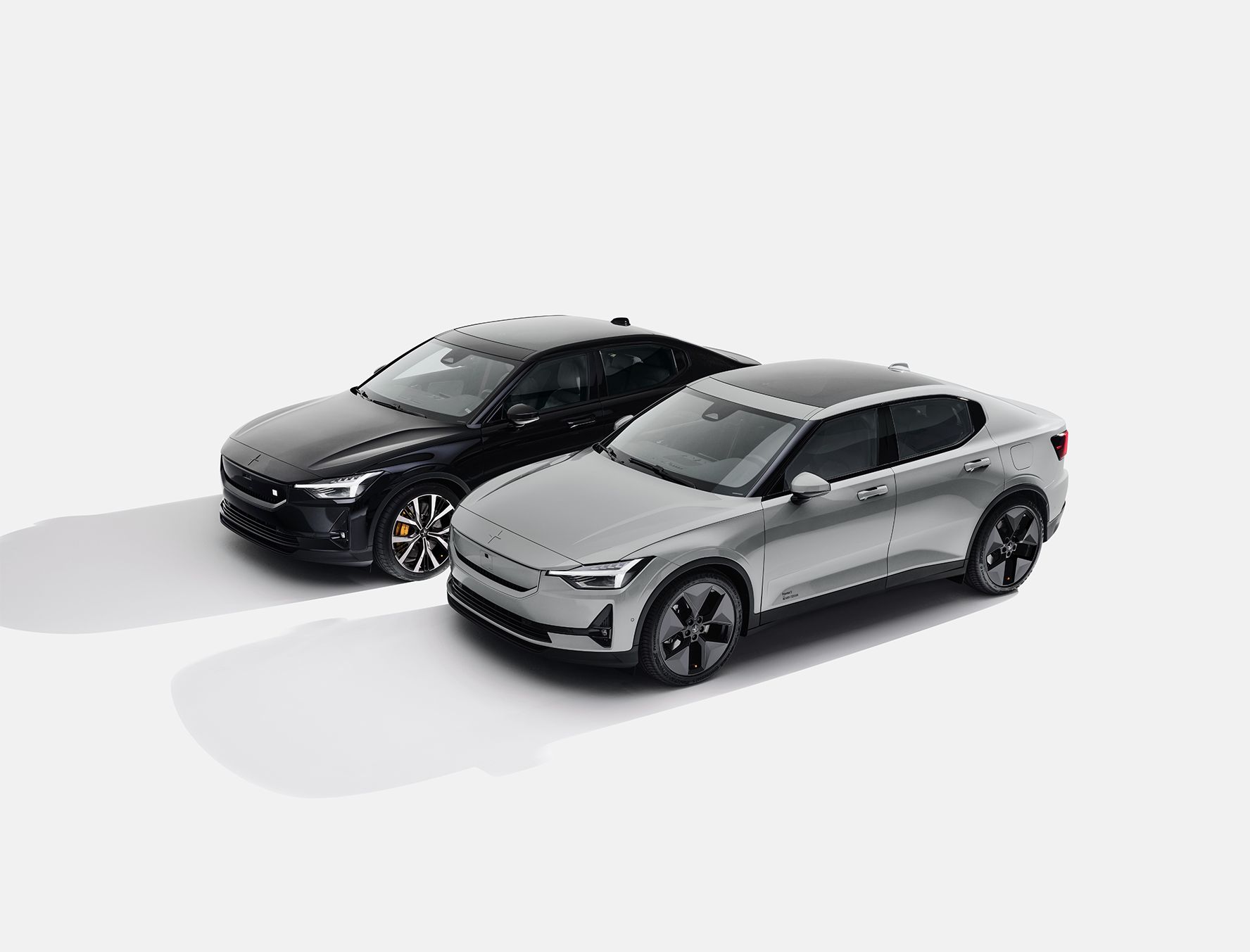 Two Polestar 2 cars, one black and one gray, shown on a white background