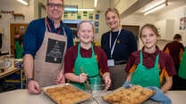 Romola Garai with students and their teacher at a school participating in the Healing Classrooms program
