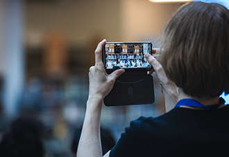 A woman taking a picture with her phone