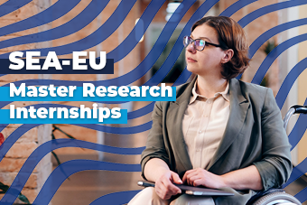 A student on a wheelchair with laptop looking on the letf