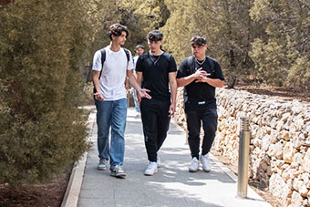 Students walking along a path at the Msida Campus