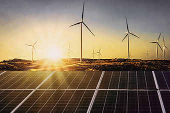 Photovoltaic panels, the sun, a wind farm