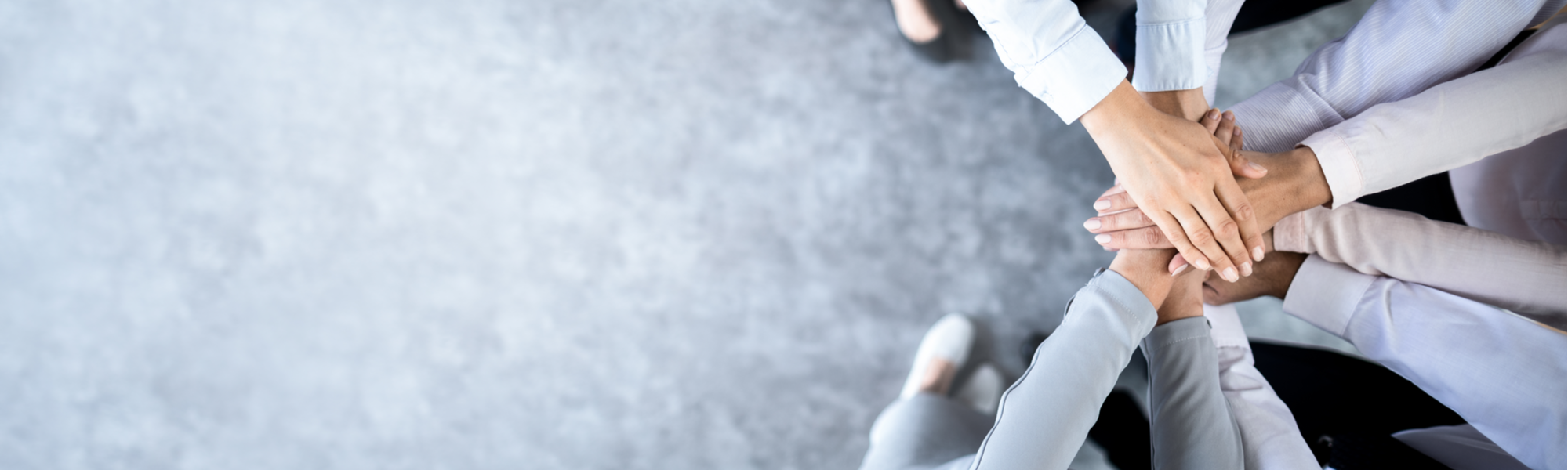 People's hands overlapping each other in a sign of unity