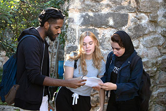 Three students talking outside
