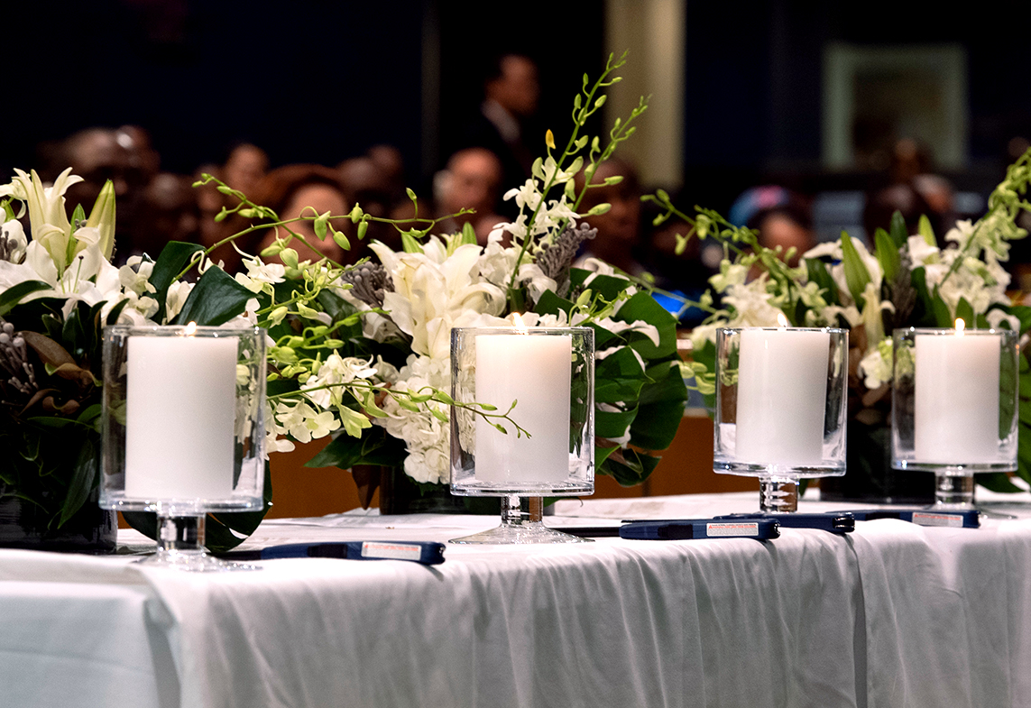 Photo of candles and wreaths on a table.