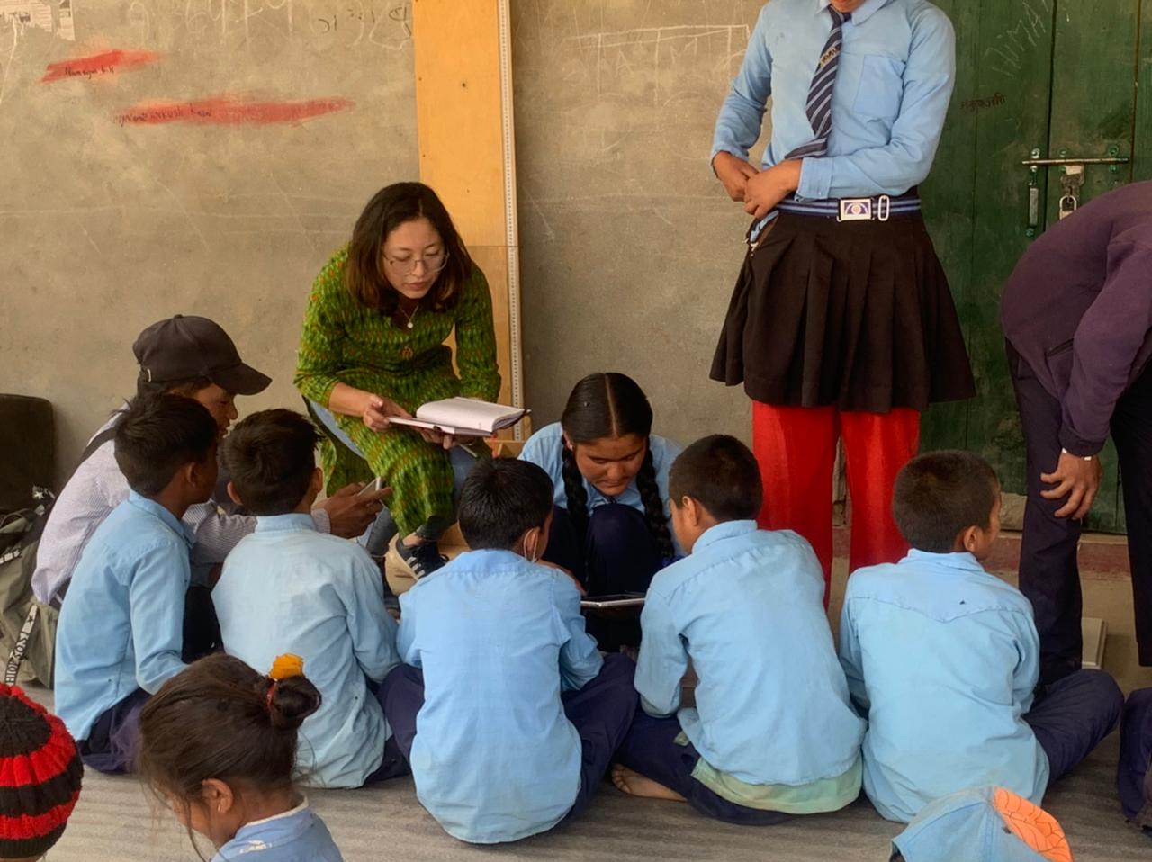 Aishworya teaching school children in Nepal