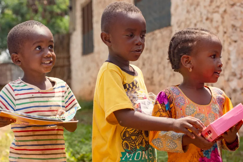 small children holding presents