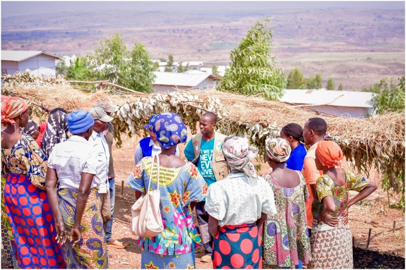 A young man engaging a group of older generation 