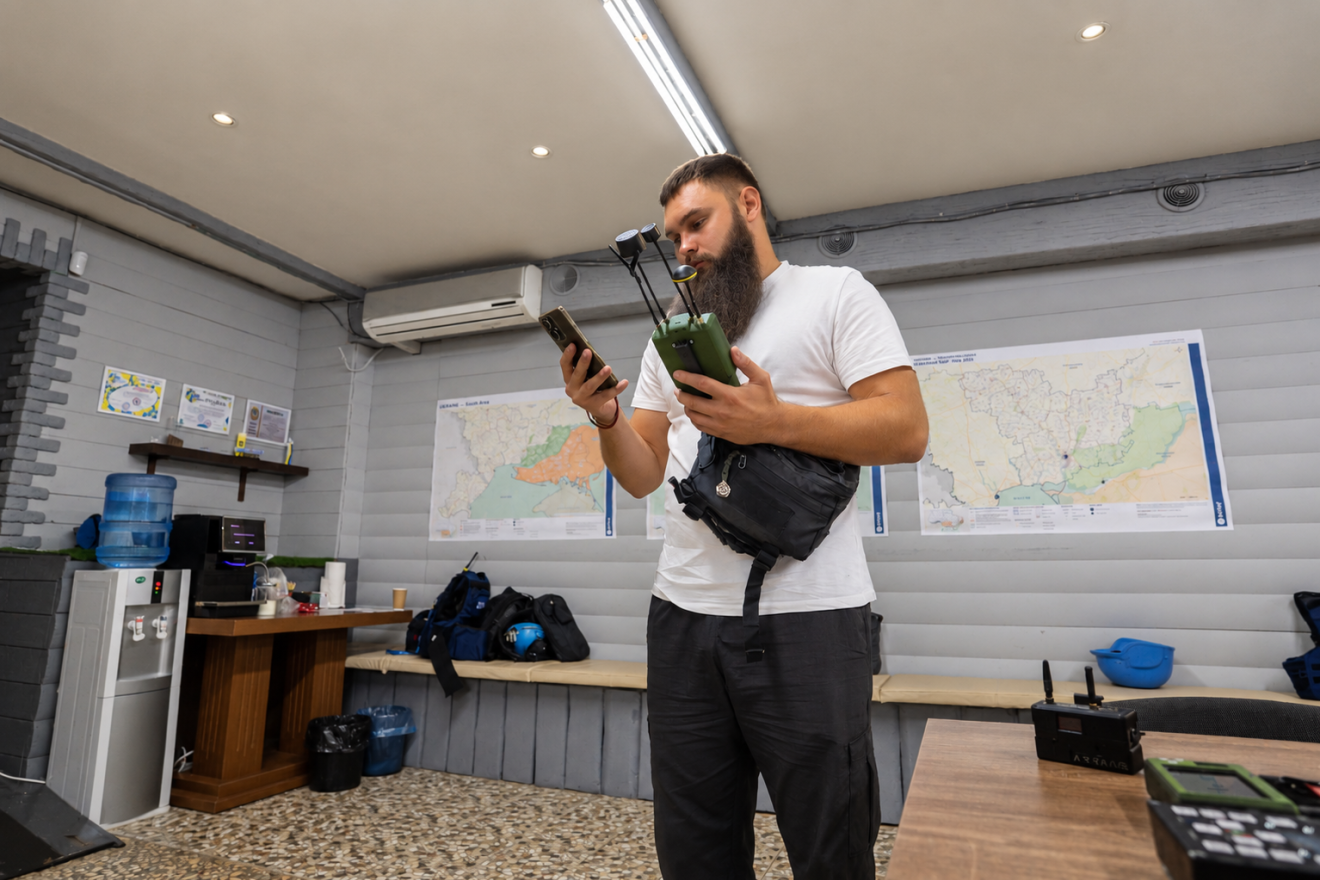 man holding drone detector
