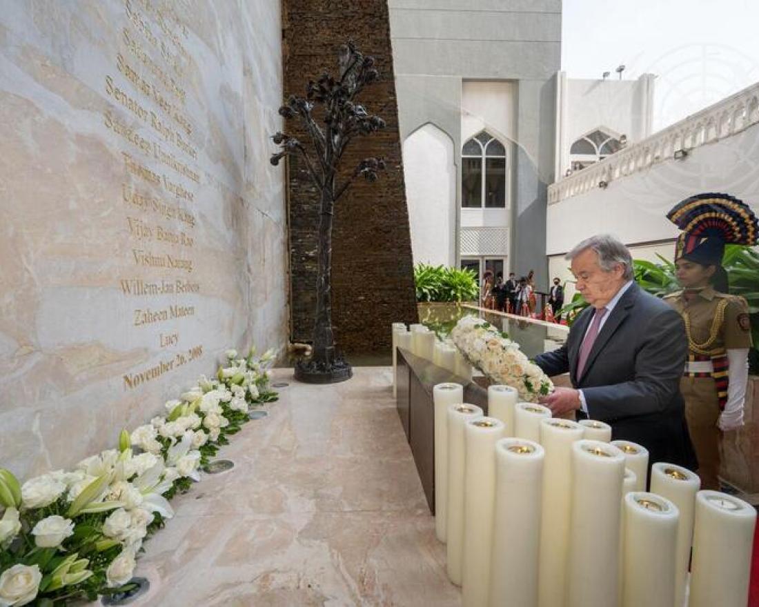 The SG kneels in prayer at the wall of rememberance