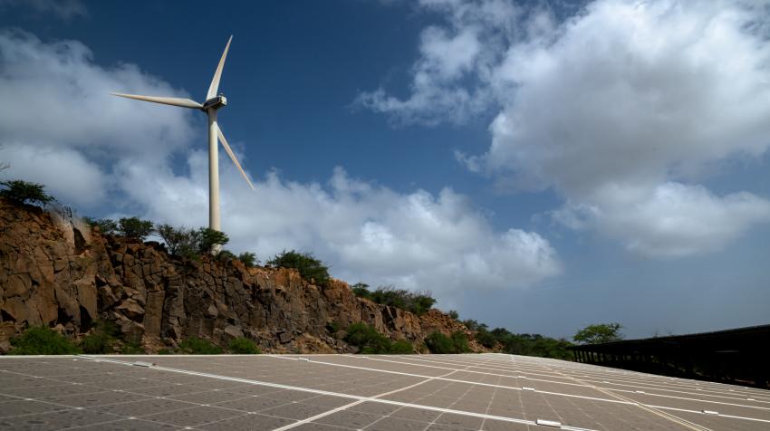 A wind turbine next to solar panels in Praia, Cabo Verde. UN Photo/Mark Garten