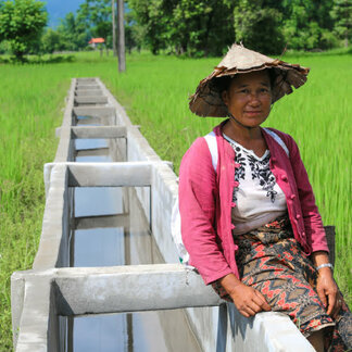 Woman sitting next to a water bed