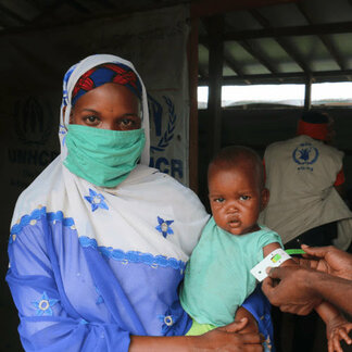 Woman and her child in a malnutrition prevention and treatment centre in Cameroon supported by WFP