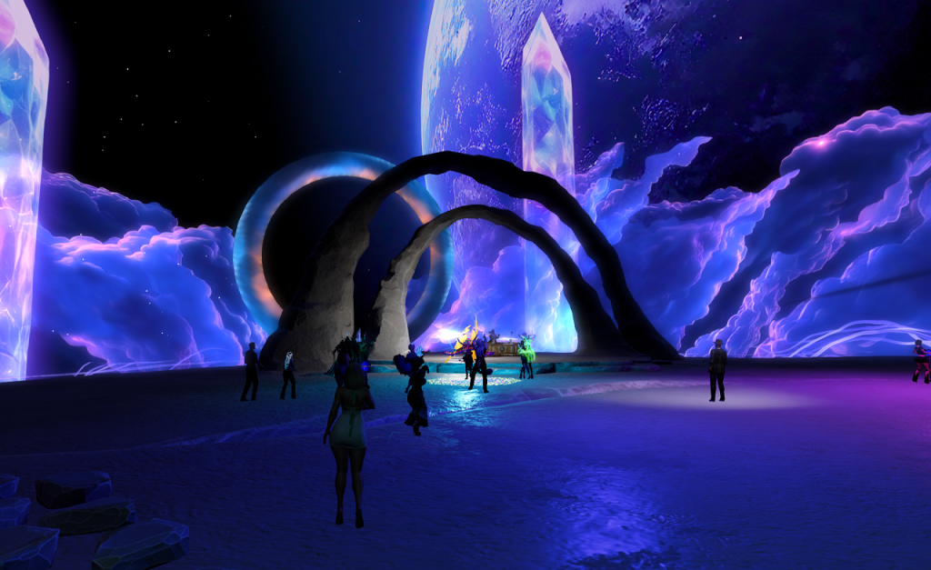 A great blue, watery planet fill half the sky in the right background. The rest of the sky is starlit blackness. Great purple and blue clouds in strange drawn-out formations fill the horizon. In the near distance, tall translucent crystals in blue, purple and white rise, widely spaced, to border a broad flat area where human figures dance. In the middle distance, beneath two rough stone arches, a DJ works his deck.