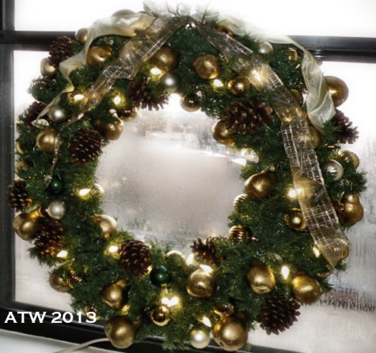 The red and green wreath from last year was ttoally revamped, using gold-leafed pears, small gol and deep green balls, and gold-tipped large pine cones. The old red and green lights were replaced with warm white LED lights, which use about 4.5 watts per 50-light string...I'm very happy I purchased them!