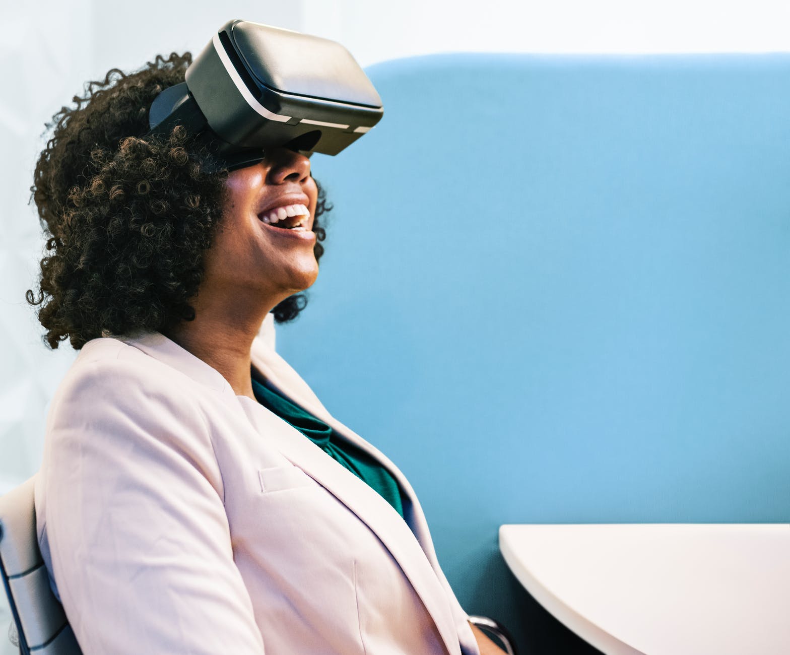 woman wearing white robe and black virtual reality headset
