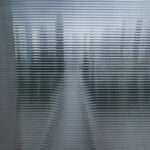 The transparency paradox when using generative AI in academic research Photograph of a landscape, seen through a ribbed glass pane