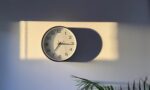 Photograph of a clock on a wall in sunlight