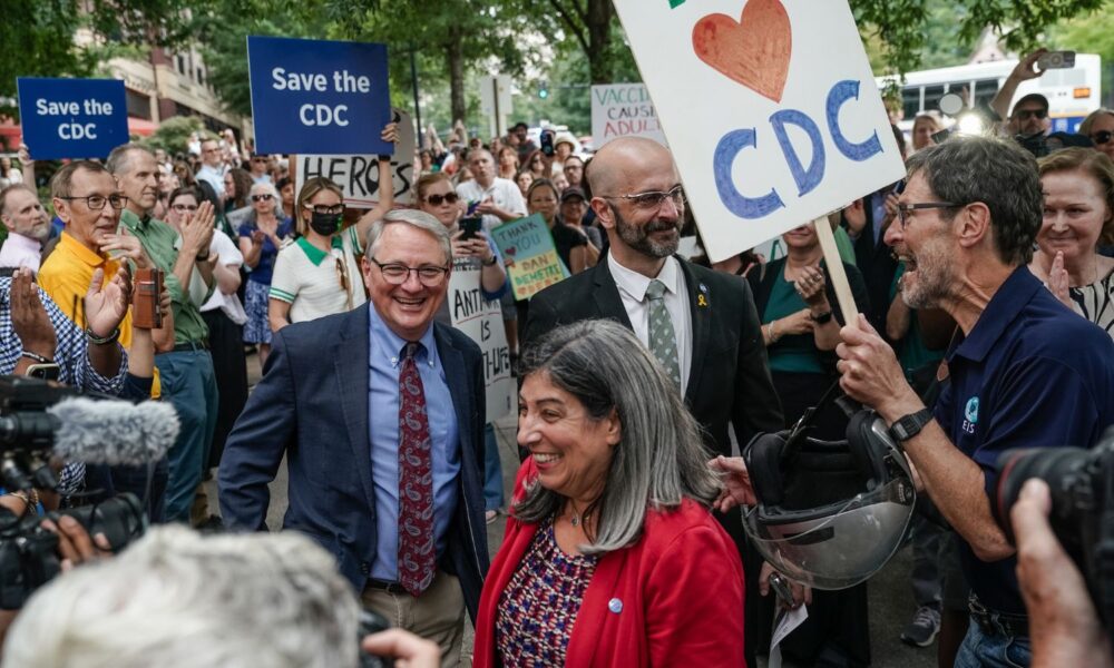 Former CDC officials Dan Jernigan, Deb Houry, and Demetre Daskalakis smile as employees and supporters of the Centers for Disease Control (CDC) line up outside the CDC global headquarters to honor the three leaders who resigned in the wake of U.S. President Donald Trump's firing of CDC director Susan Monarez, on August 28, 2025 in Atlanta, Georgia.