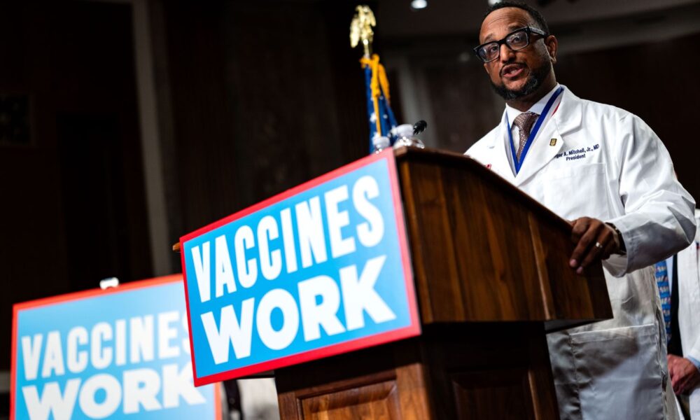 In front of a podium hung with signs that read VACCINES WORK, Dr. Roger Mitchell of the National Medical Association speaks during a news conference on vaccine safety and efficacy with Senator Bernie Sanders, doctors, and public health experts on Capitol Hill on September 9, 2025 in Washington, DC.