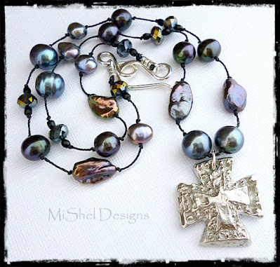 Handknotted Pearl necklace of blue freshwater pearls and silver colored pewter coptic cross Freshwater pearls in shades of blue and gray handknotted on black silk cord and spaced 3/4 inch apart with a silver tones pewter medieval cross pendant
