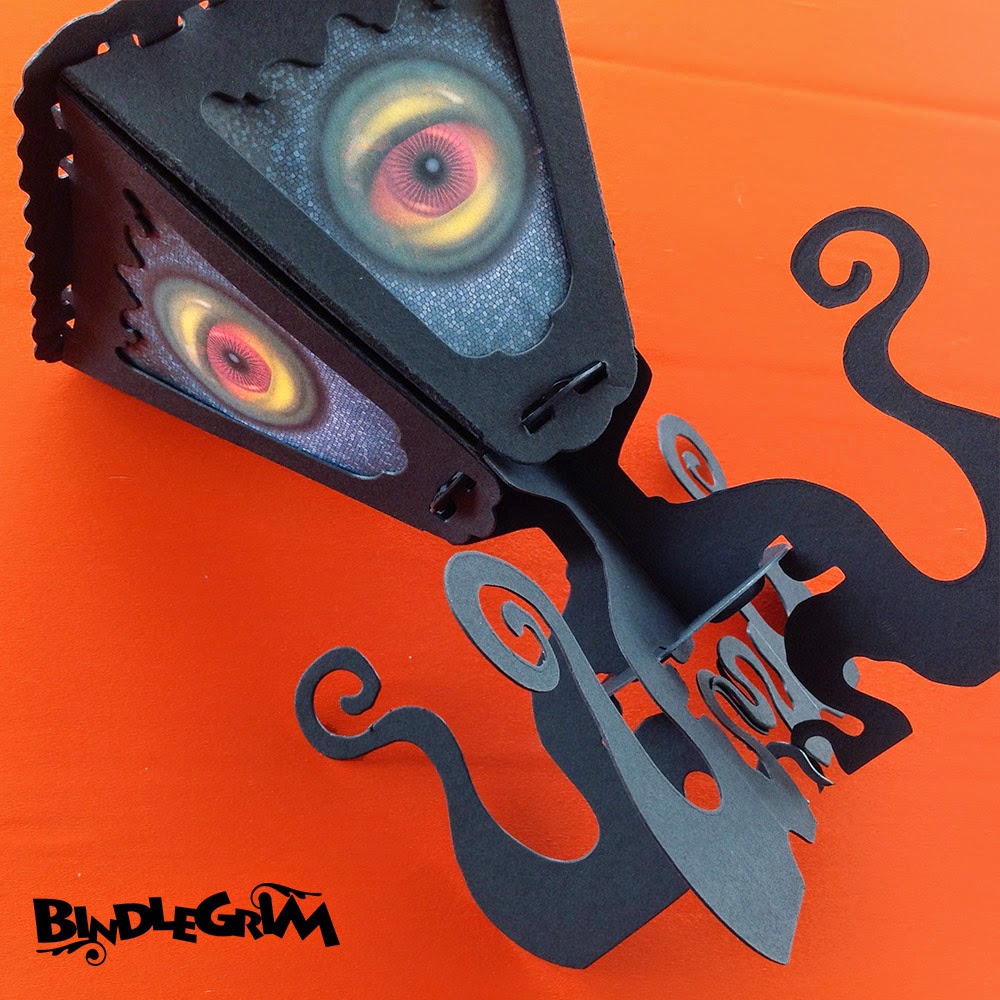 Monster lantern decor for Halloween by Bindlegrim Eight-limbed octopus monster black silhouette with large eye-balls by Bindlegrim for Bindlegoods Spooklights series