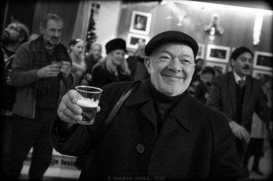 Legendary guitar Virtuoso and life-long "Filibeli" (see body text for definition), Ognian Videv, wearing an English-style Kangol and holding, in lieu of his signature guitar, a signature glass of bear, December, 2013. (Fuji X100, specs as per above.) Click on photo to enlarge.